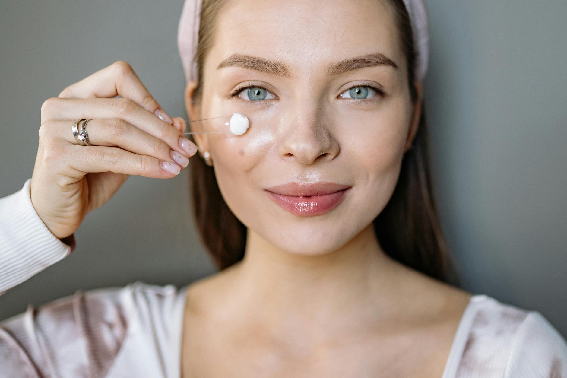 close up shot of woman applying face cream