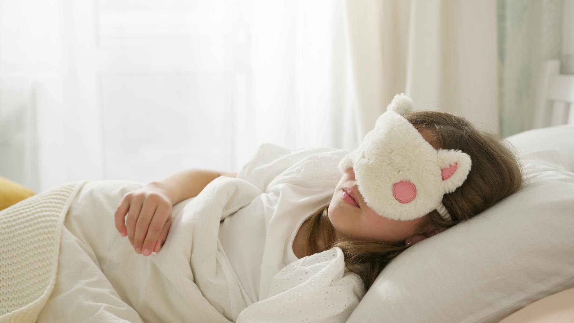 a girl sleeping on the bed